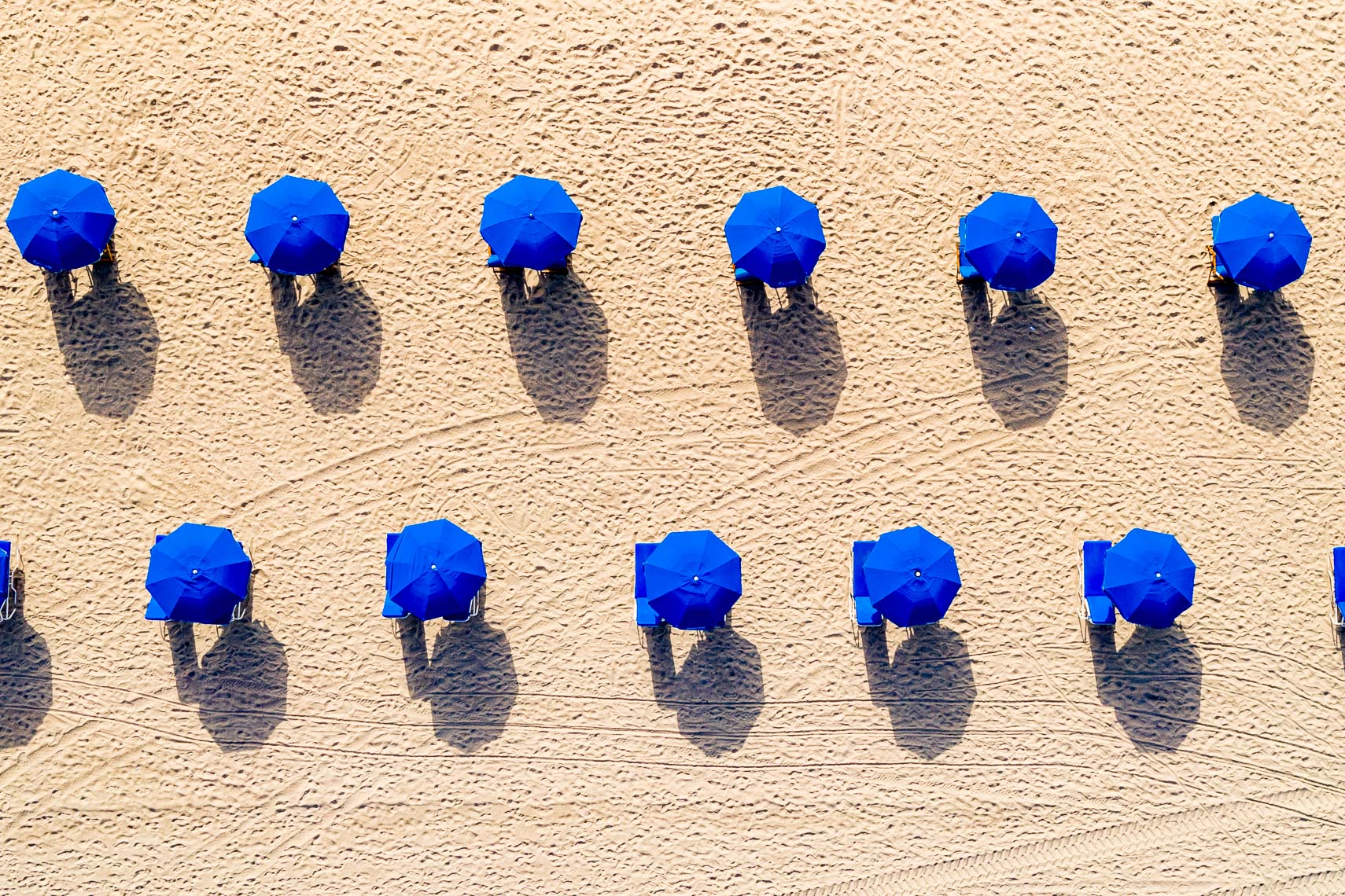 Blue Umbrellas On The Beach
