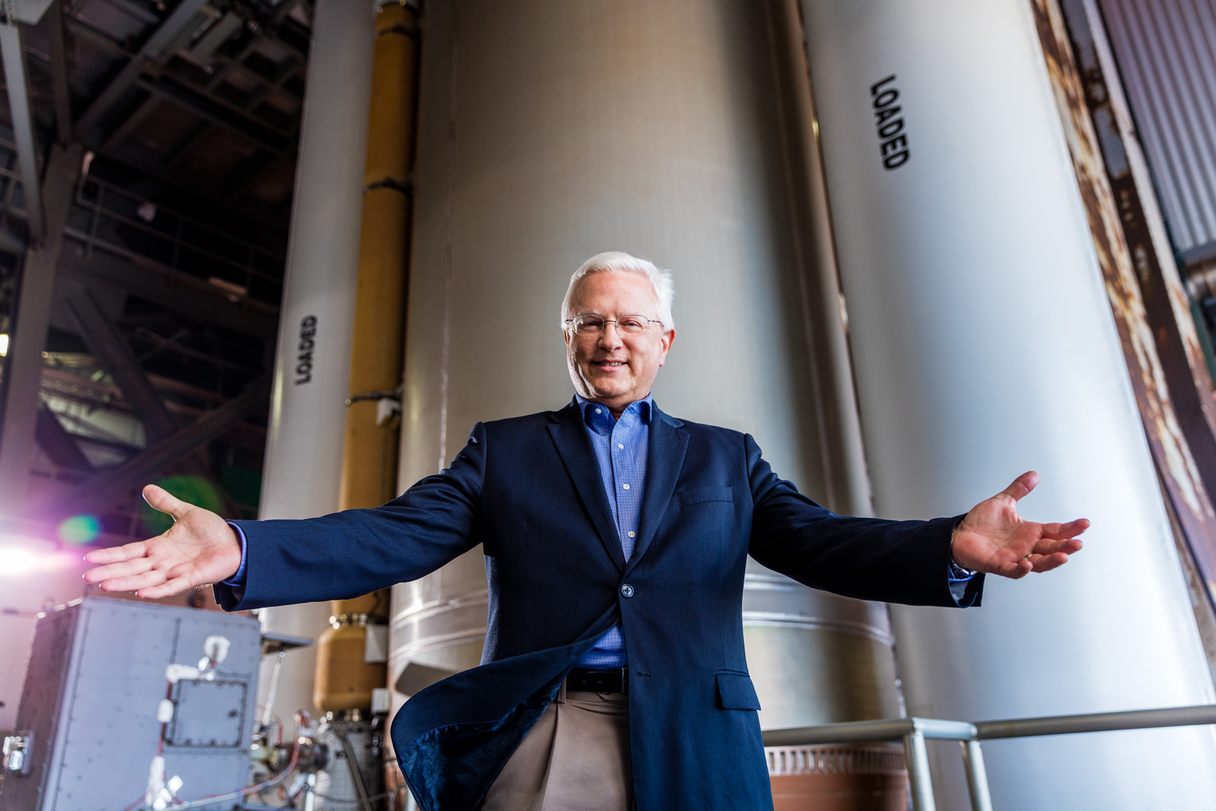 Aerospace Executive United Launch Alliance photographed in front of an Atlas V Rocket
