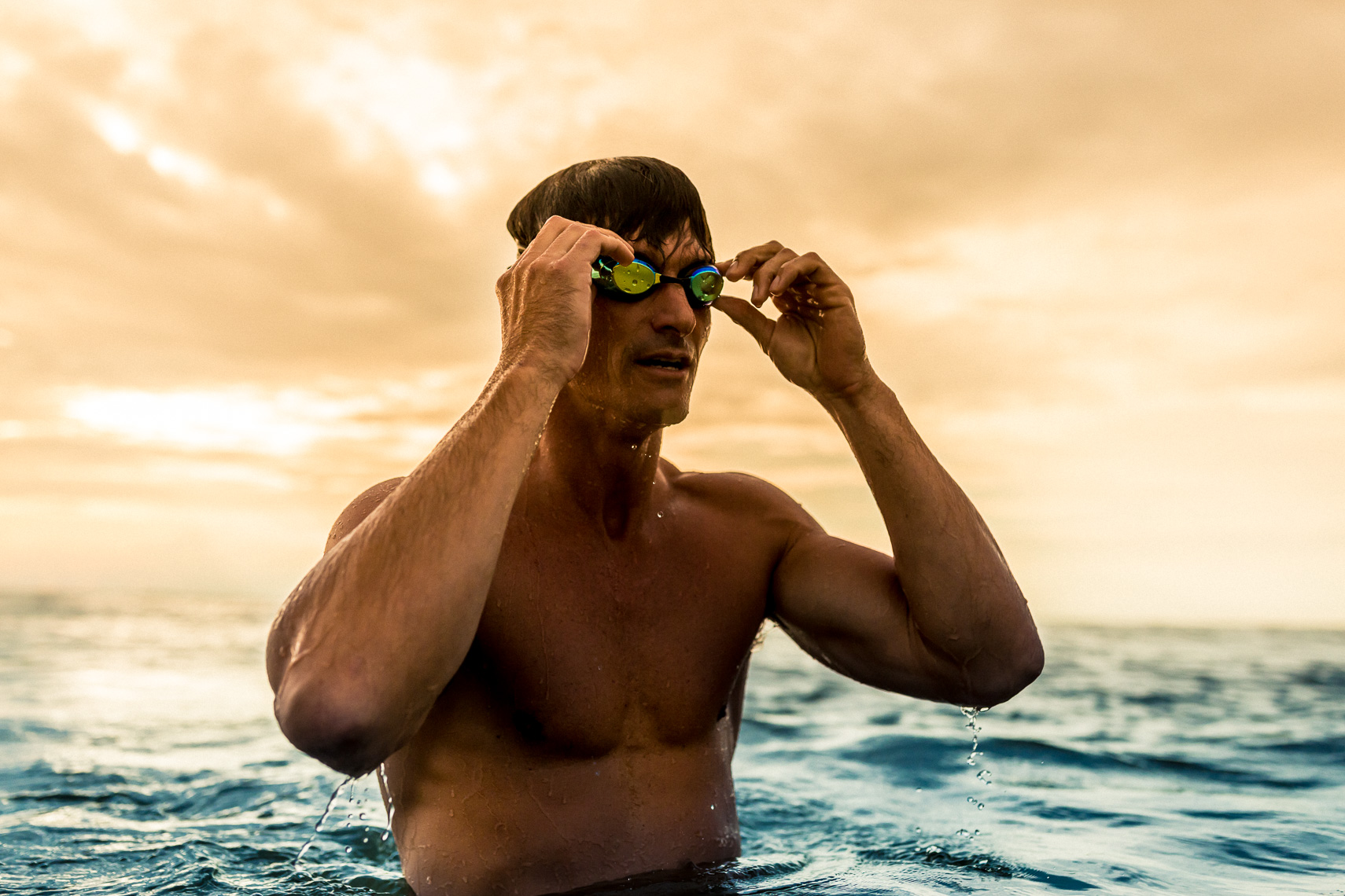 A man goes for a swim in the ocean at sunrise in Florida | Commercial Photographer in