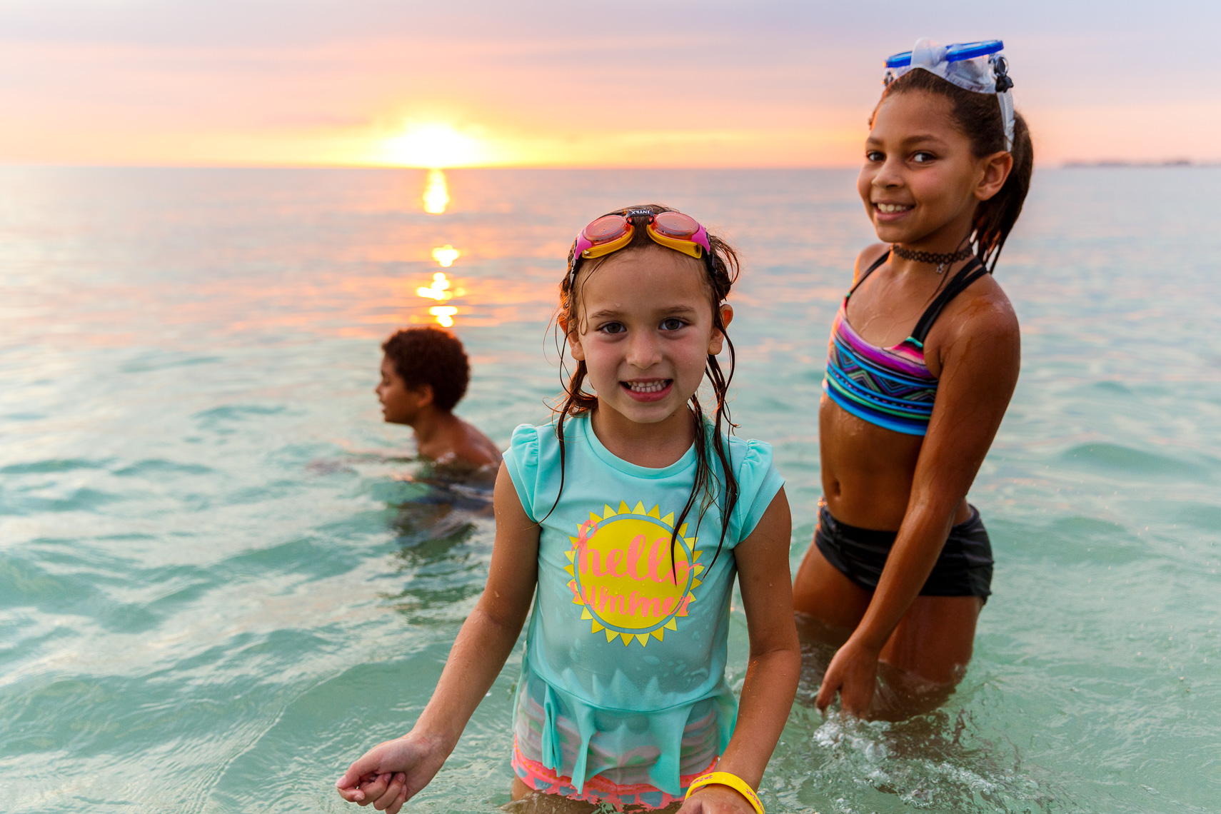 Children play in the Gulf of Mexico at sunset