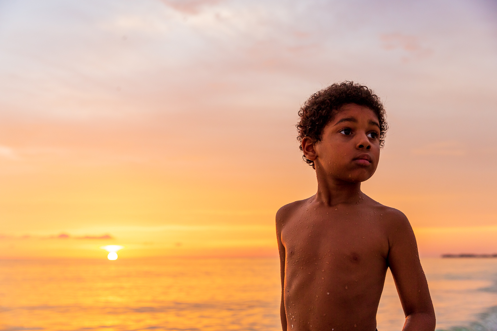 Children play in the Gulf of Mexico at sunset
